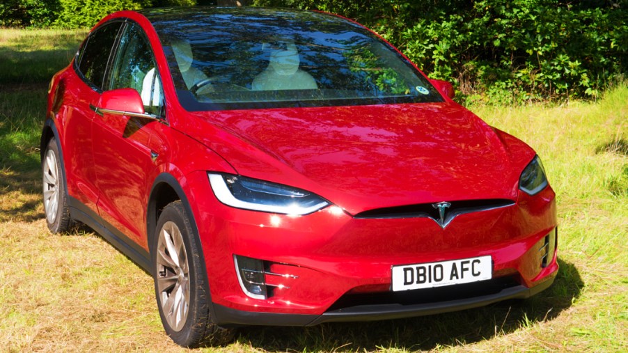 A red 2017 Tesla Model X electric vehicle.