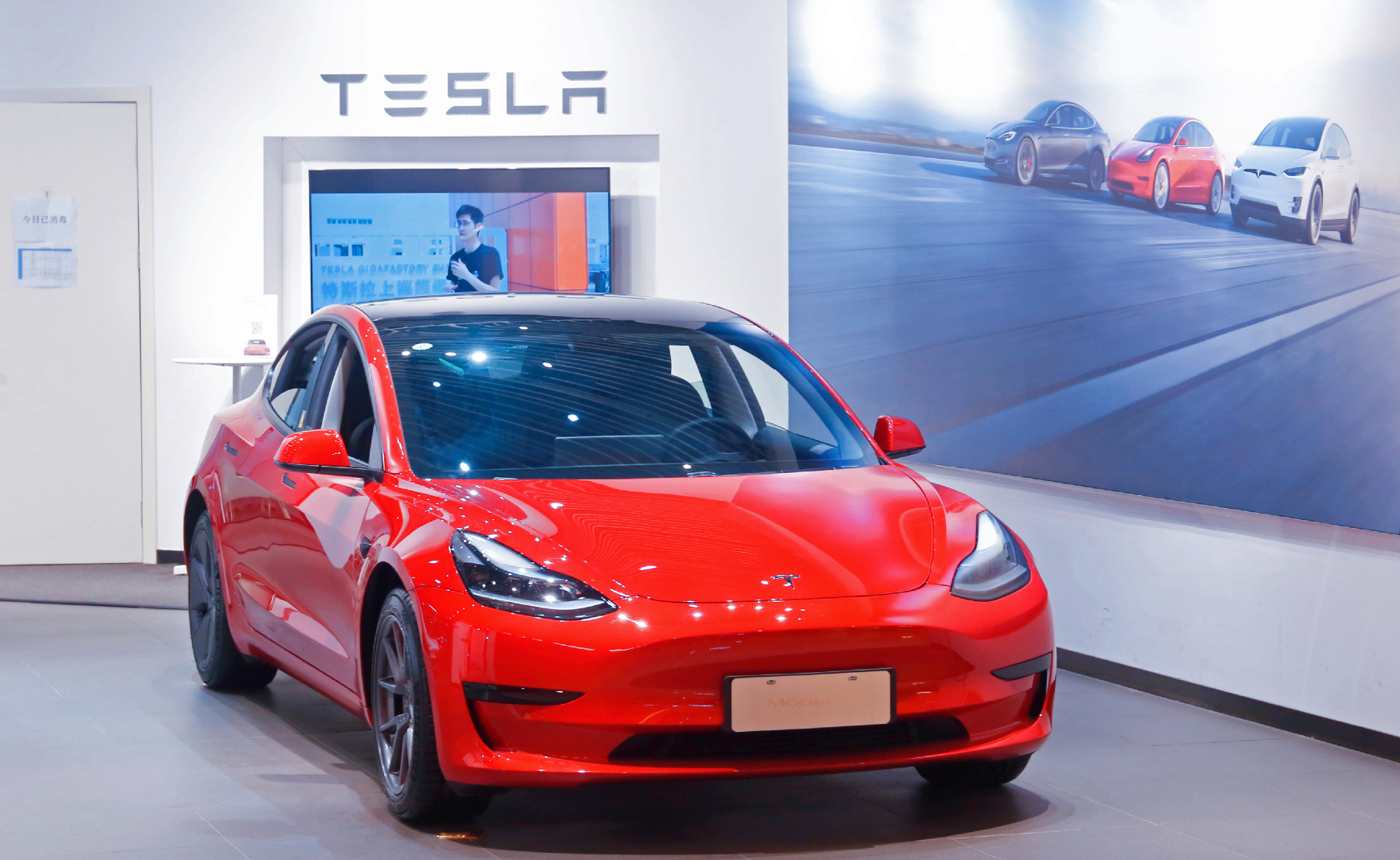 A red Tesla Model Y car at a Tesla sales store in downtown Shanghai, China, April 2, 2021.