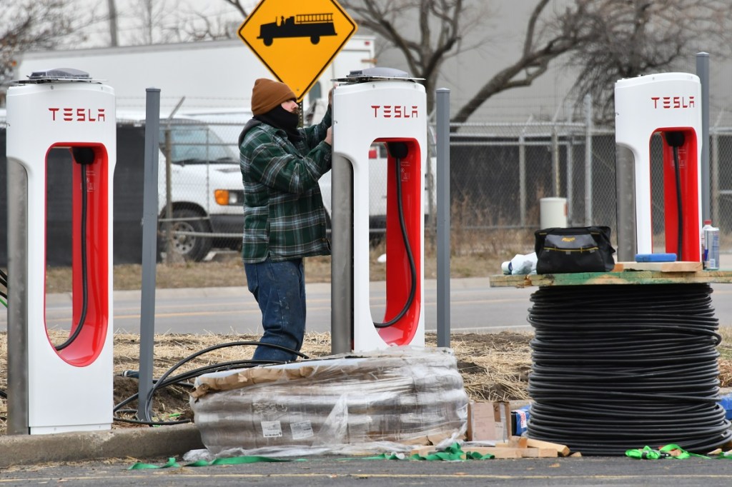 A Tesla Supercharger being installed. 