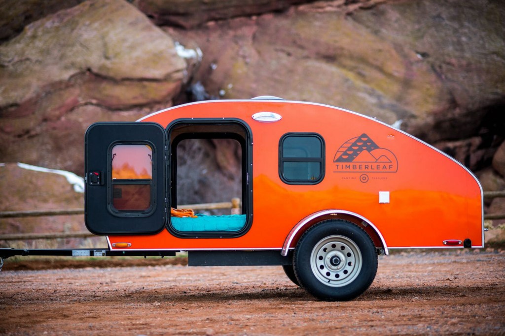 An orange Timberleaf Classic Teardrop Trailer parked, the Timberleaf Classic Teardrop Trailer is one of the coolest teardrop campers
