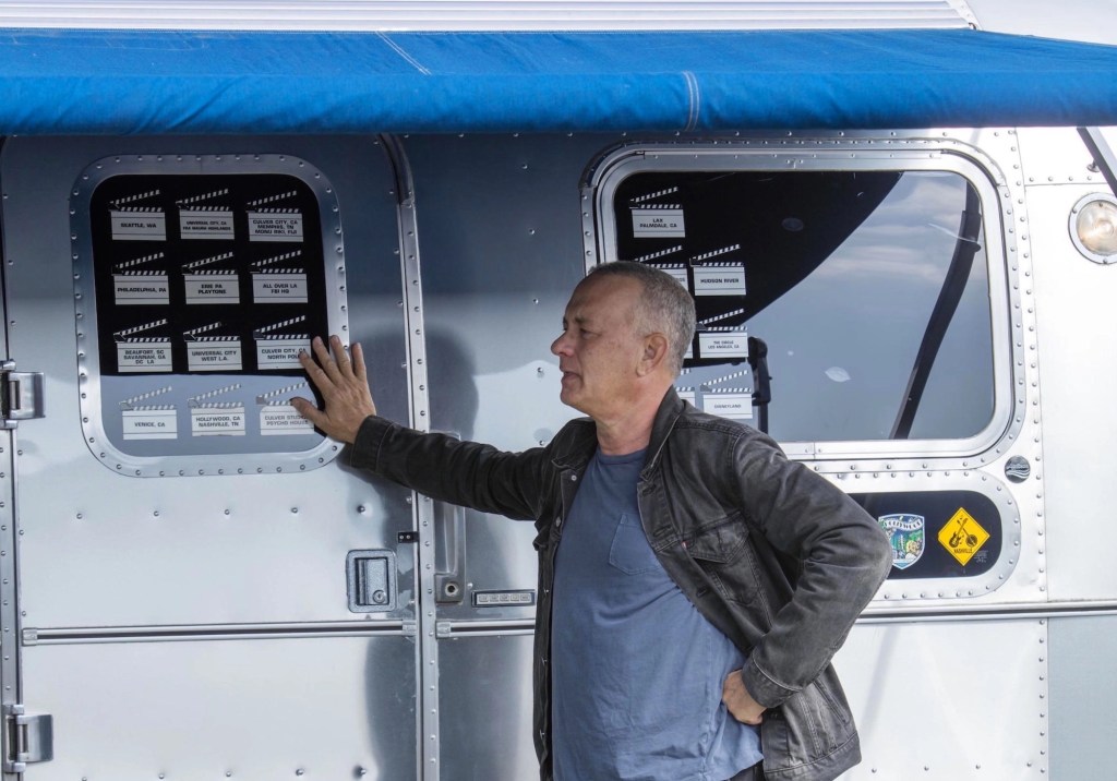 Tom Hanks standing with his Airstream Model 34 