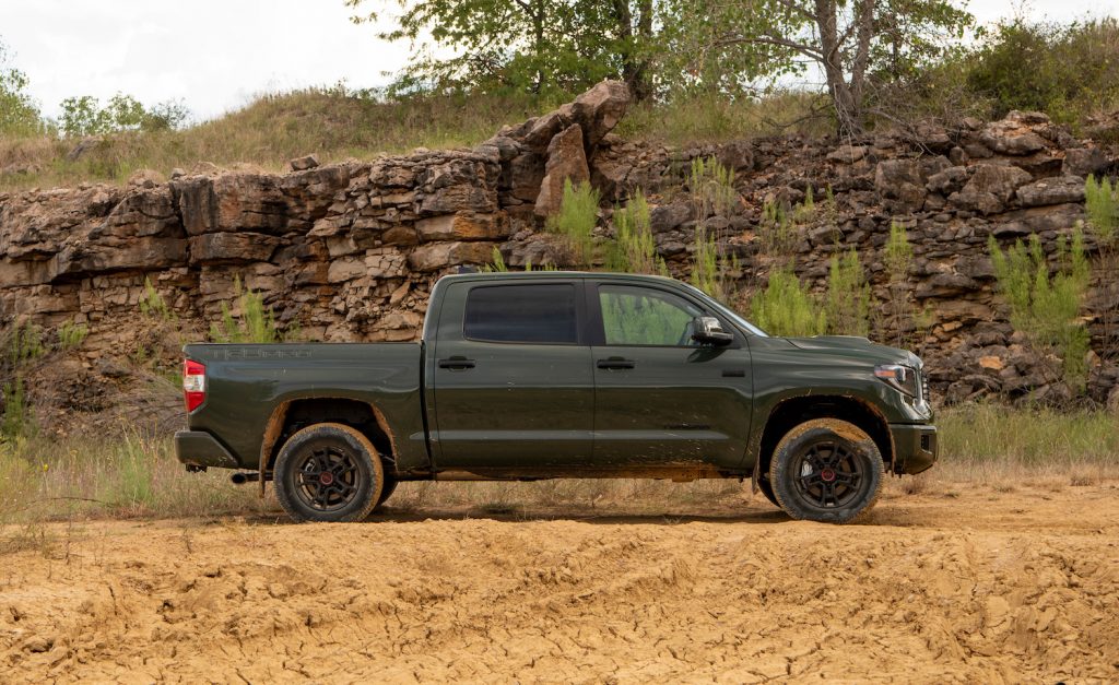 A green Toyota Tundra parked in the wilderness
