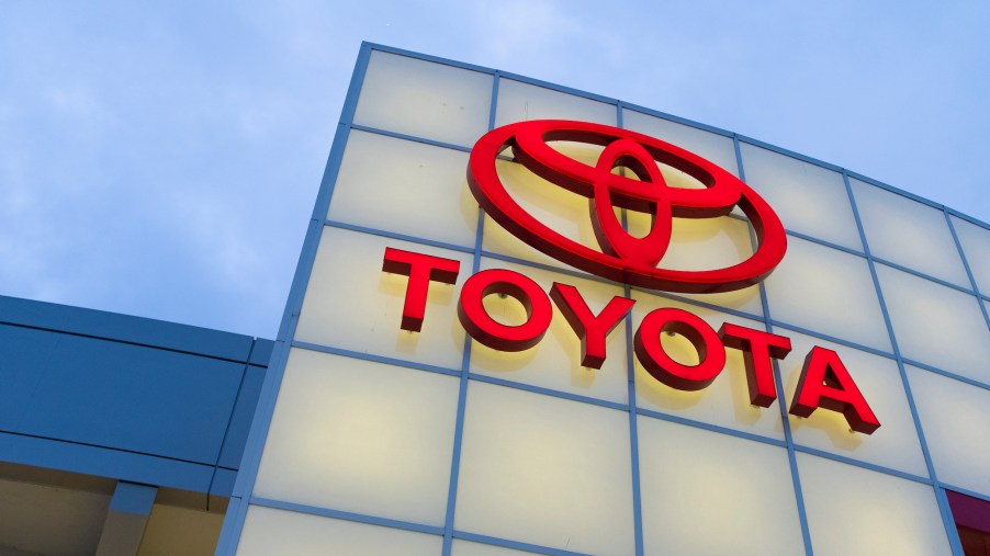 A lighted red Toyota logo on a car dealership in San Jose, California, in November 2019