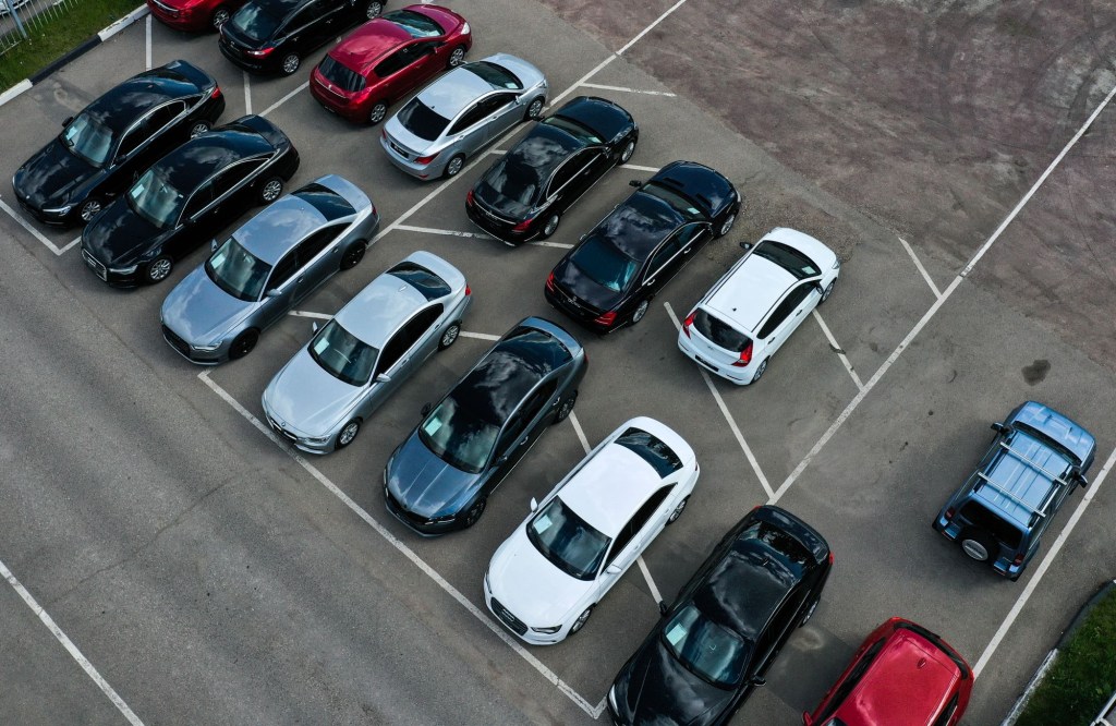 An overhead shot of cars lined up in a used car lot
