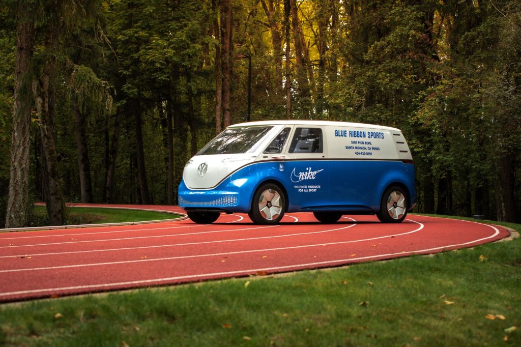A Volkswagen ID. Buzz model with Nike and Blue Ribbon branding parked on a running track