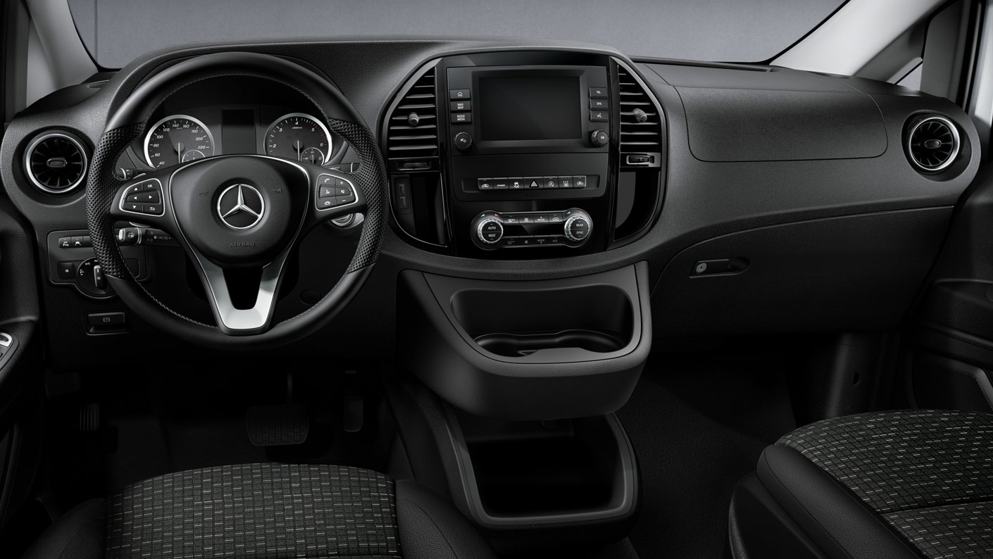 The interior dash view of the 2021 Mercedes-Benz Metris with the three-pointed star on the steering wheel.