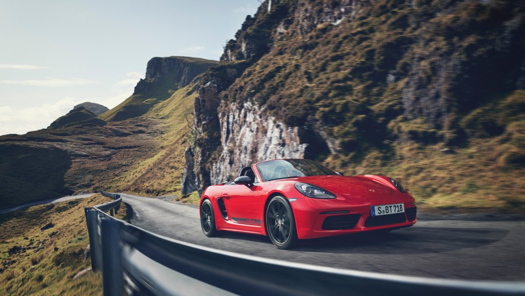 The red 718 Boxster on a twisty cliffside road