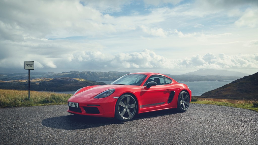 A red 718 Cayman overlooking a bay
