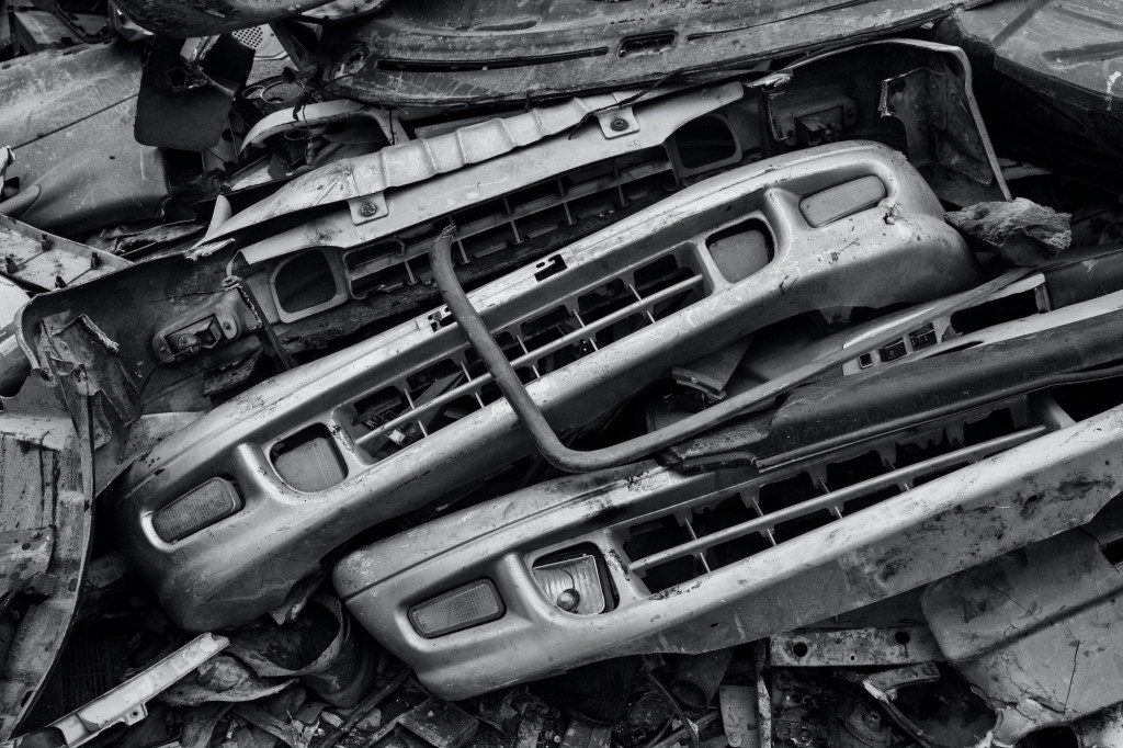 Bumpers from high-polluting vehicles taken off the road by authorities are seen piled up at an auto scrapyard.