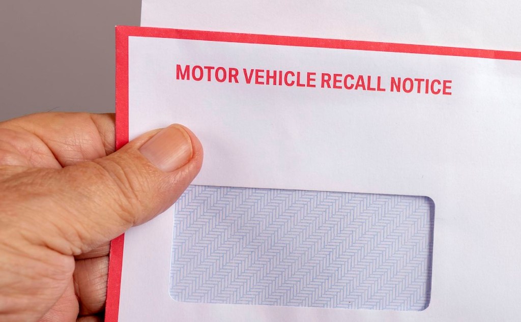A white envelope with 'motor vehicle recall notice' written in red uppercase font