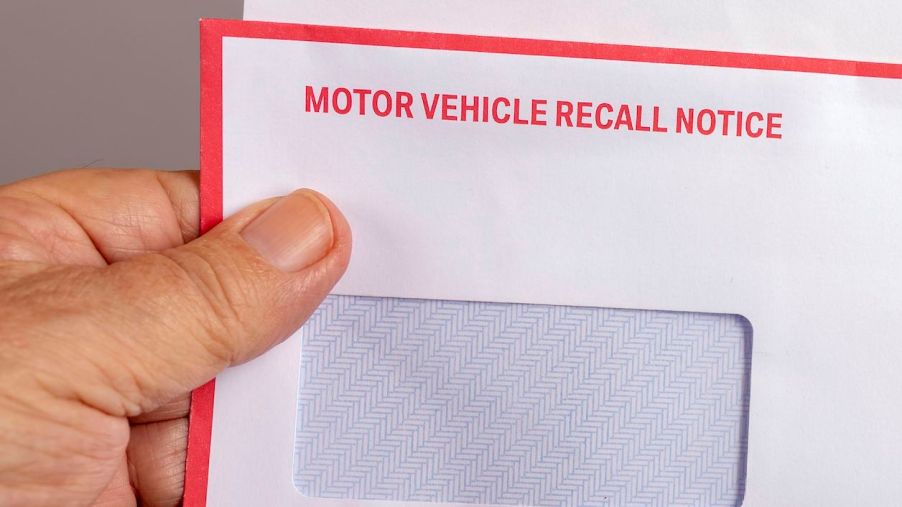 A white envelope with 'motor vehicle recall notice' written in red uppercase font