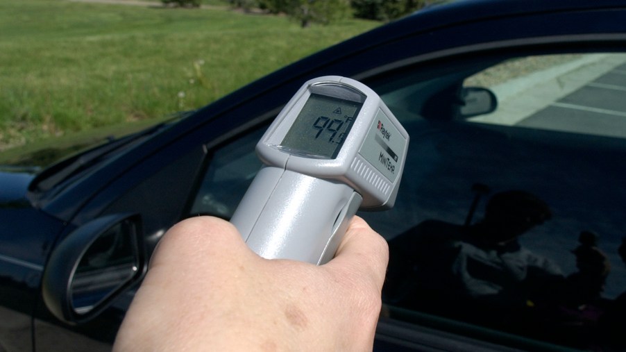 Man taking temperature of a car's interior