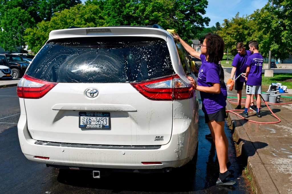 7th-graders wash a Toyota Sienna minivan for fundraiser in Wellsville, New York