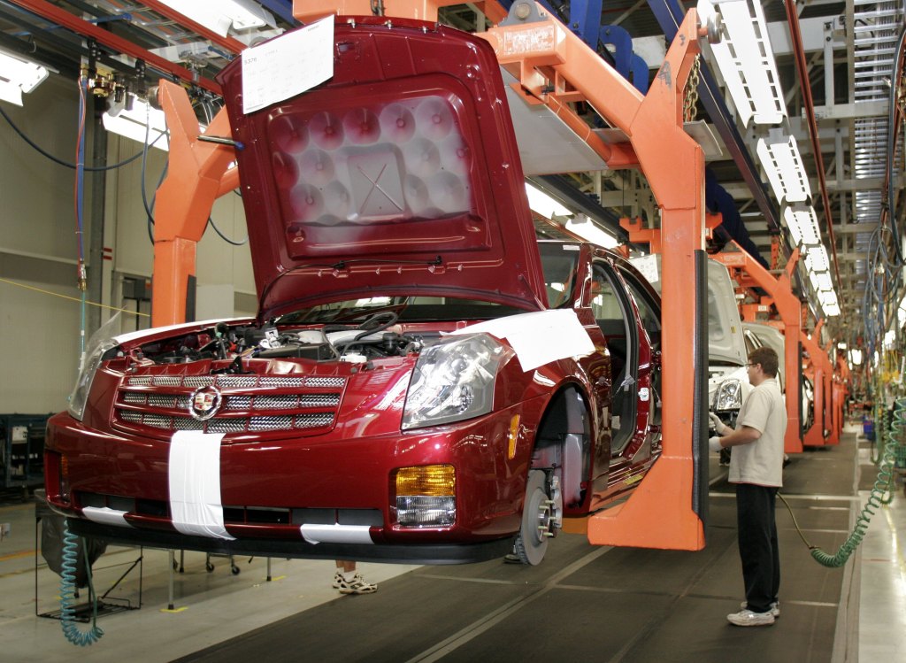  A General Motors worker assembles a new Cadillac on the assembly line at the GM Lansing Grand River Plant.