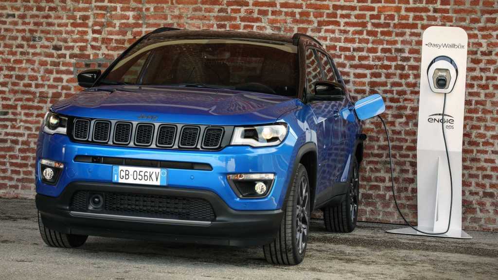 A blue 2021 Jeep Compass 4xe plugged in to a charger