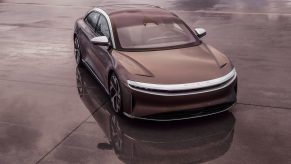 A brown Lucid Air electric car parked on concrete