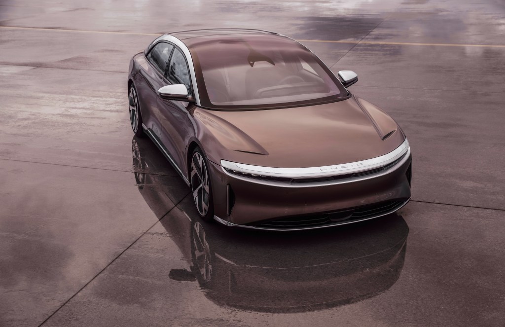 A brown Lucid Air parked on concrete
