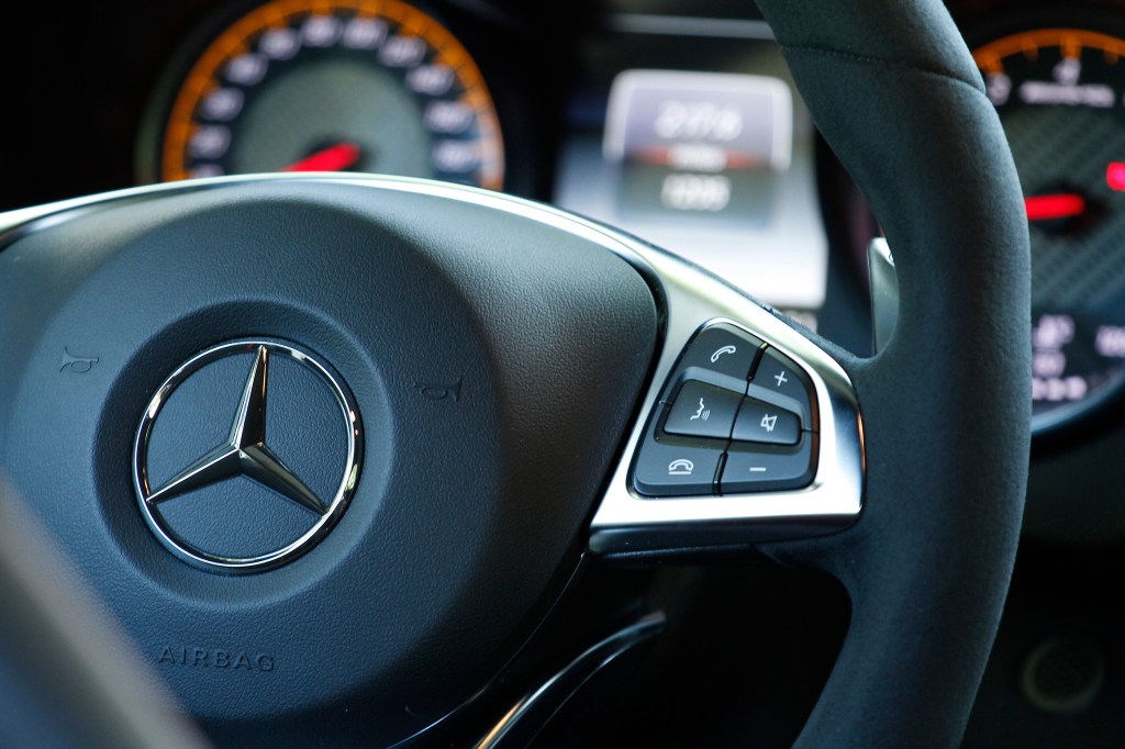 A foam-covered steering wheel and paddle shifters show its race inspiration in the 2016 Mercedes-AMG GT S.