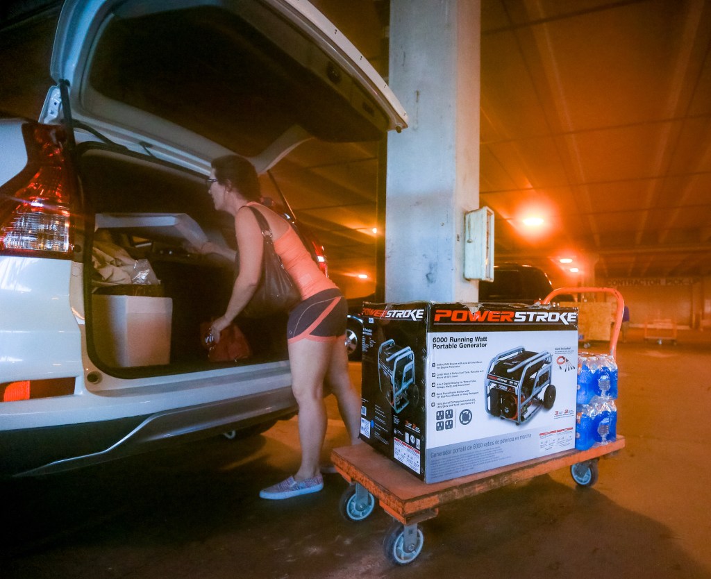 South Florida resident Andrea Kmetz buys a portable generator and bottled water in preparation for Hurricane Matthew on October 5, 2016, in Fort Lauderdale, Florida