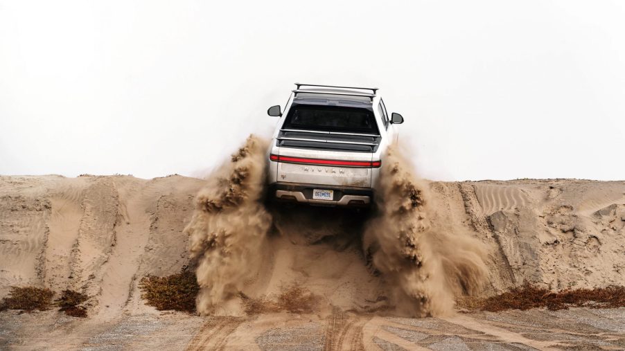Rivian R1T climbing a sandy hill as they patent a new Star Wars inspired K-turn feature