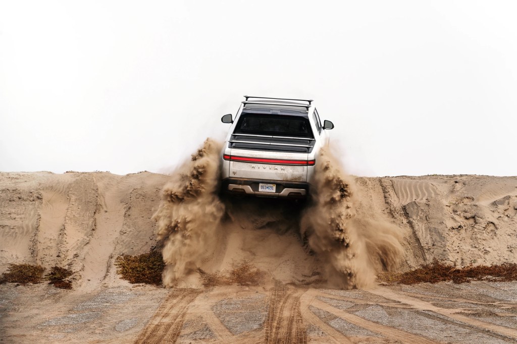 Rivian R1T climbing a sandy hill as they patent a new Star Wars inspired K-turn feature