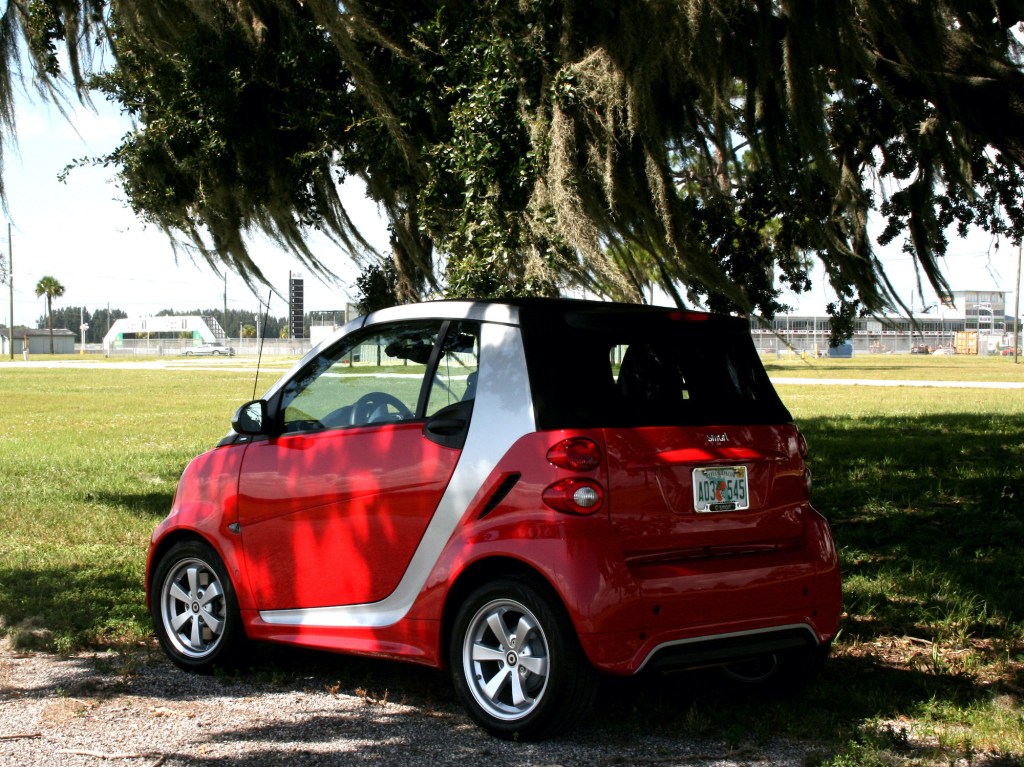 The Smart Car parked in the shade of an oak tree.