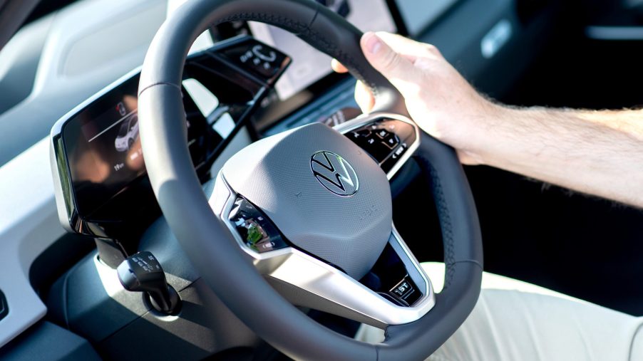 A man holds the steering wheel of a new VW ID.3