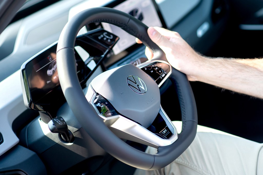 A man holds the steering wheel of a new VW ID.3