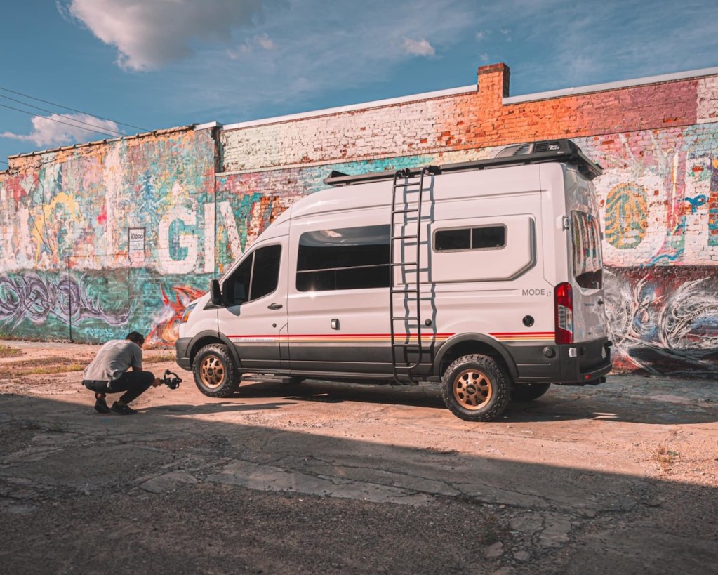 Storyteller 4x4 camper van parked in front of graffiti