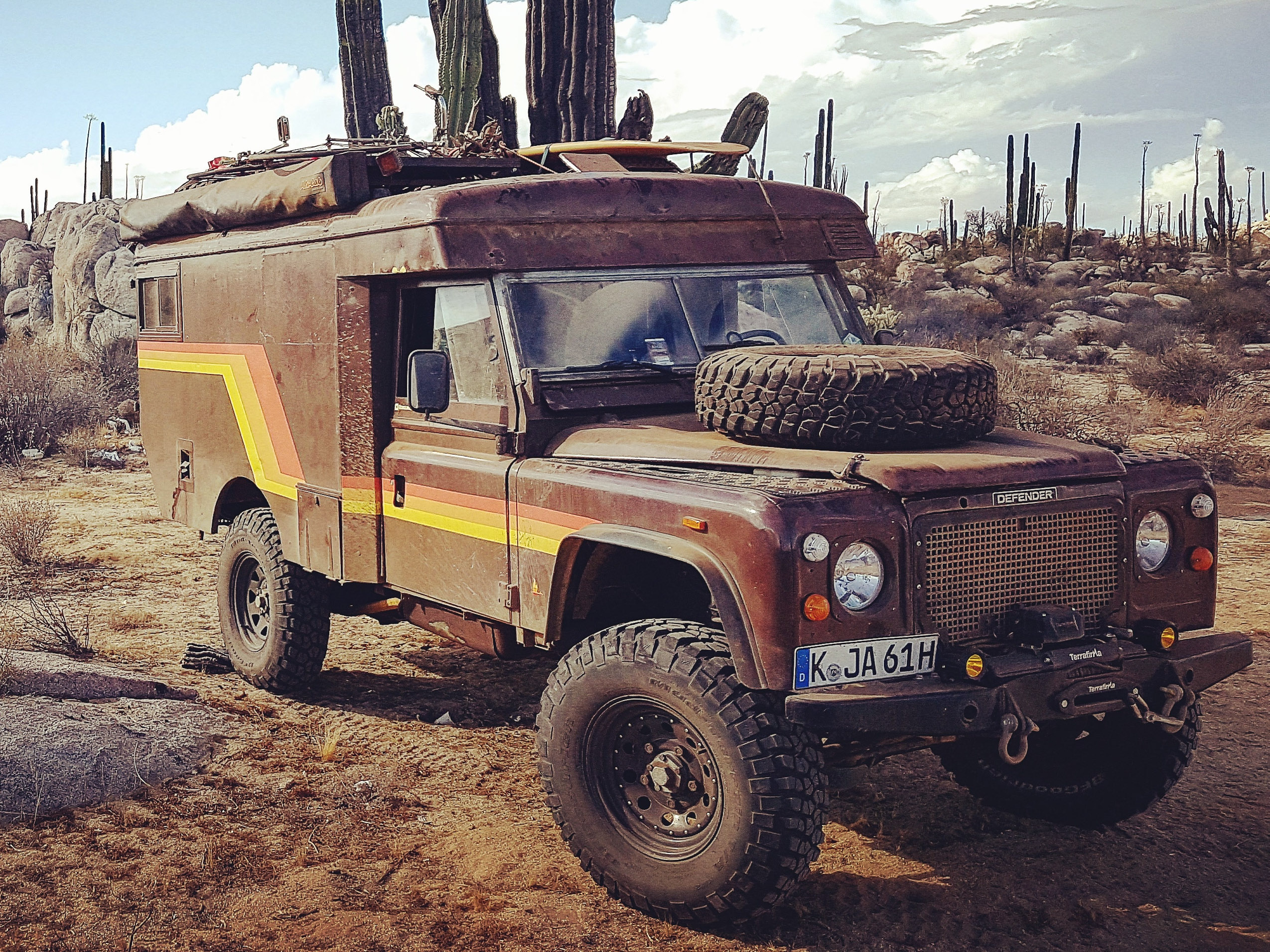Vintage Land Rover overland camper parked in the desert