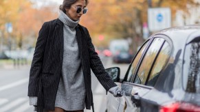 A woman opening the door of her BMW car