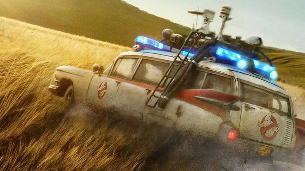 screen shot from the trailer for the new Ghostbuster: Afterlife film showing the Ecto-1 drifting through a barley field