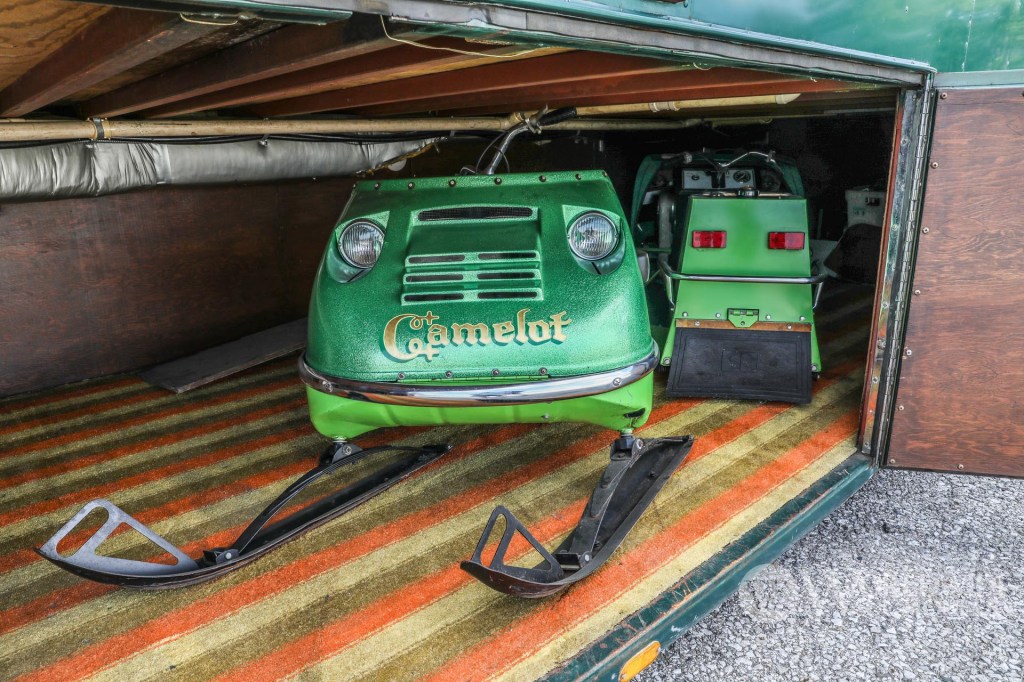 1974 Camelot Cruiser basement with two vintage snowmobiles
