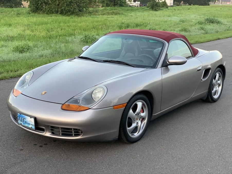 A tan-silver 2002 Porsche Boxster S on a road
