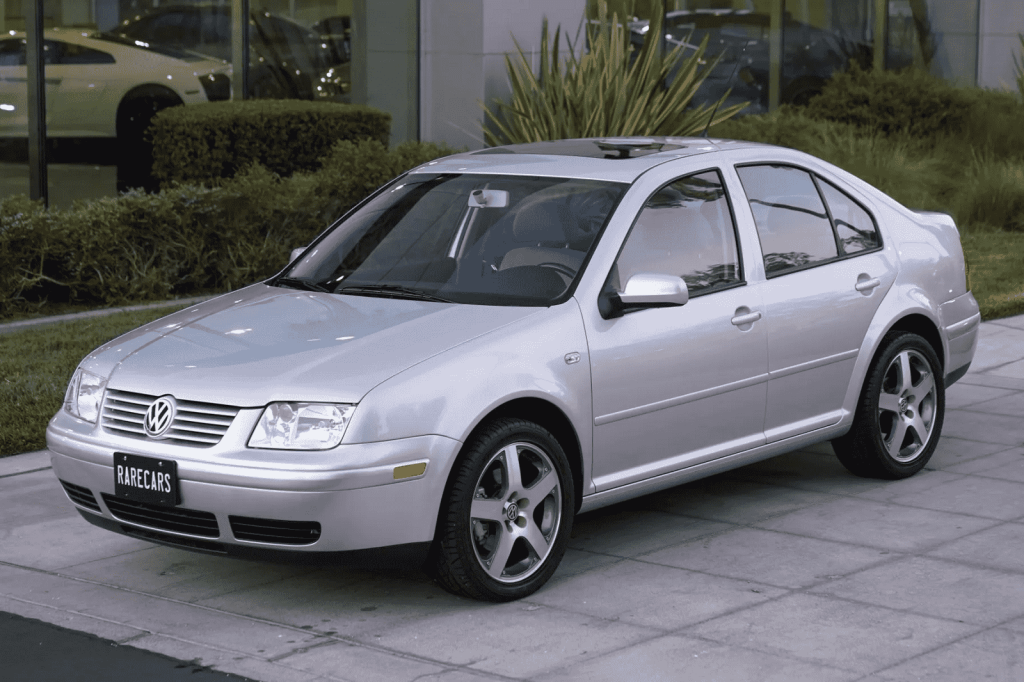 A silver 2002 Volkswagen Jetta sedan is shown parked at left facing angle