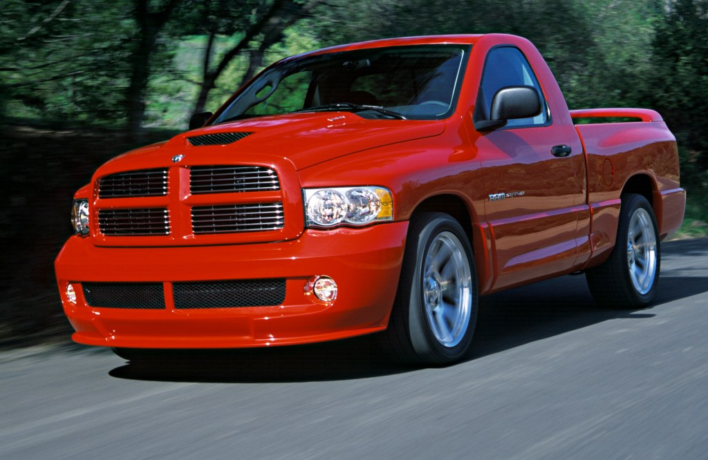 A red 2004 Dodge Ram SRT-10 driving on a racetrack