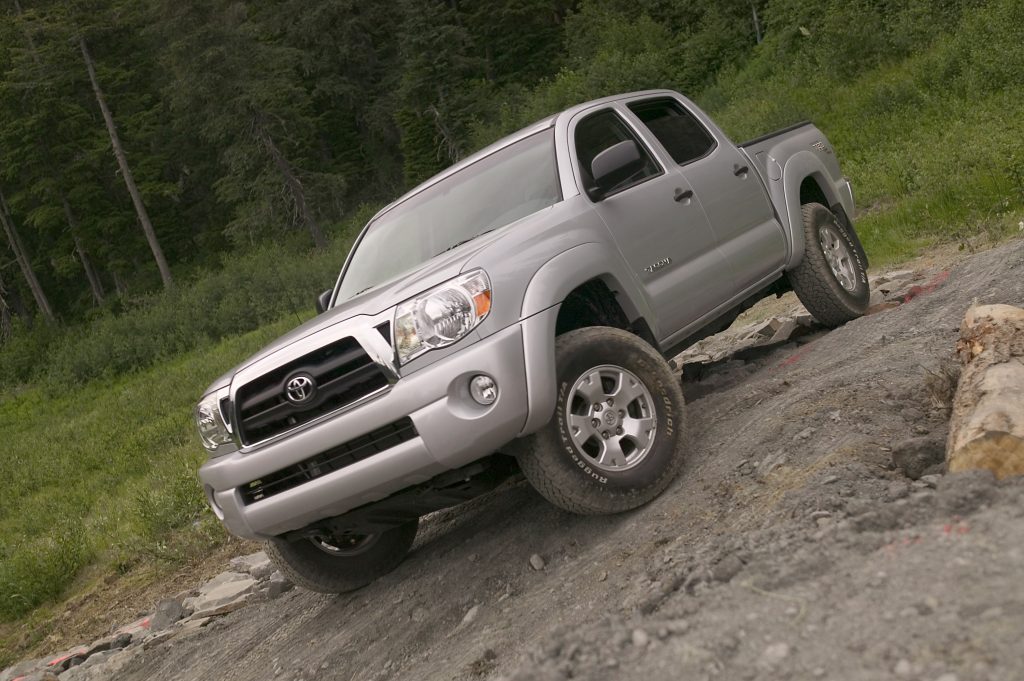 a silver 2007 used Toyota Tacoma driving off-road on a rocky trail 