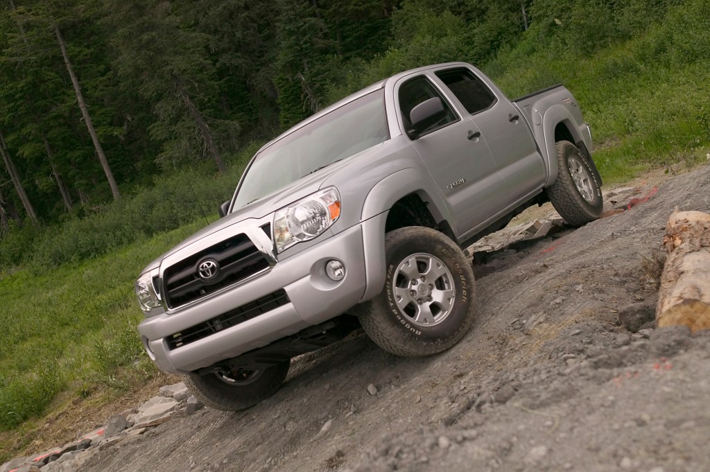 a silver 2007 used Toyota Tacoma driving off-road on a rocky trail 