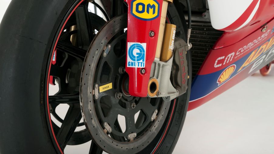 The lower half of a red 2006 Ducati 999 Superbike's gold inverted fork