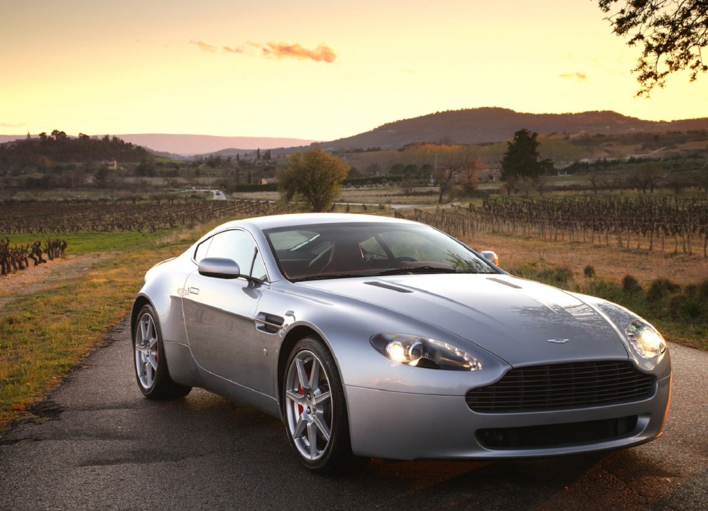 A silver 2007 Aston Martin V8 Vantage on a sunset country road