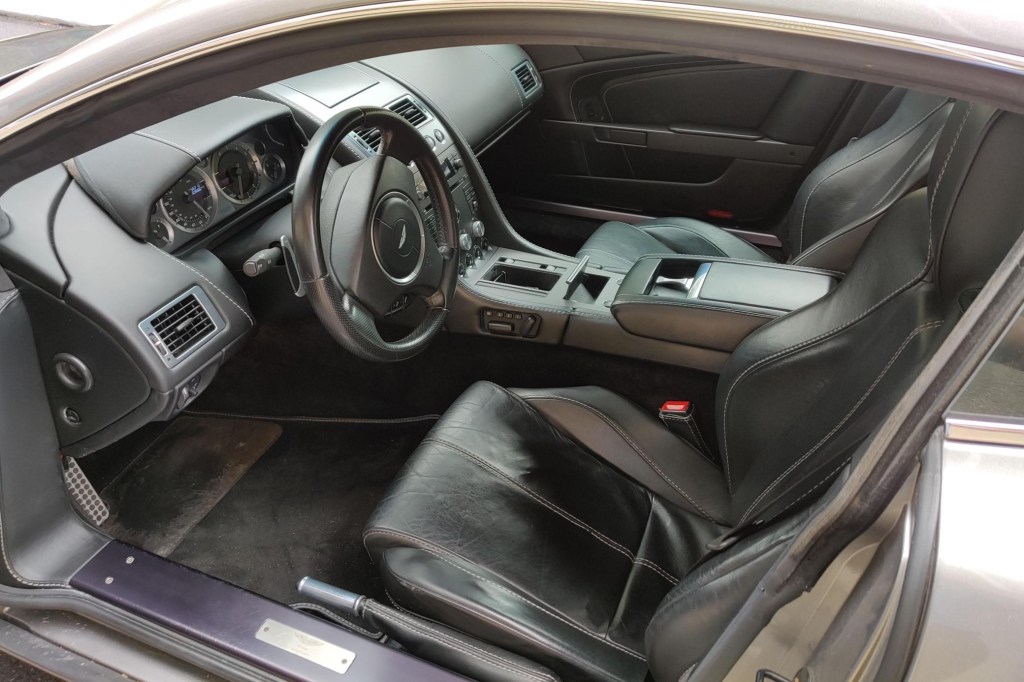 The black-leather interior of a 2008 Aston Martin V8 Vantage