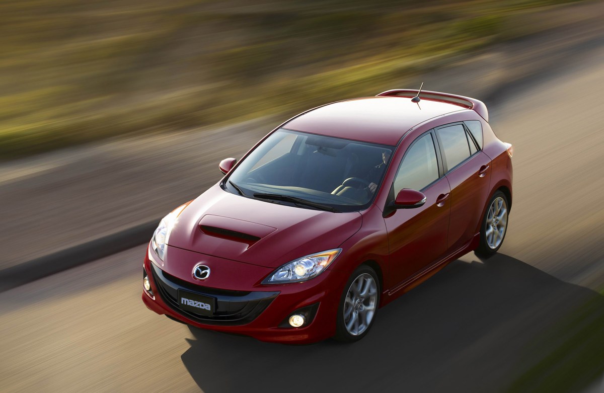 A red 2012 Mazdaspeed 3 photographed from a high angle while driving.