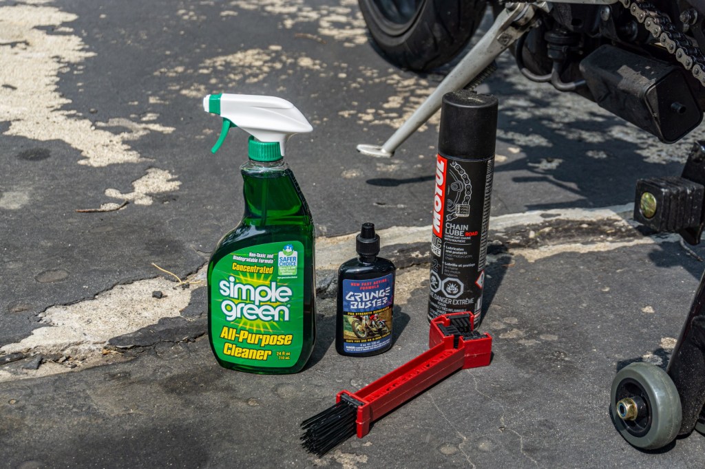 Cleaning solution, degreaser, motorcycle chain lube spray, and a motorcycle chain brush for cleaning and lubricating the chain