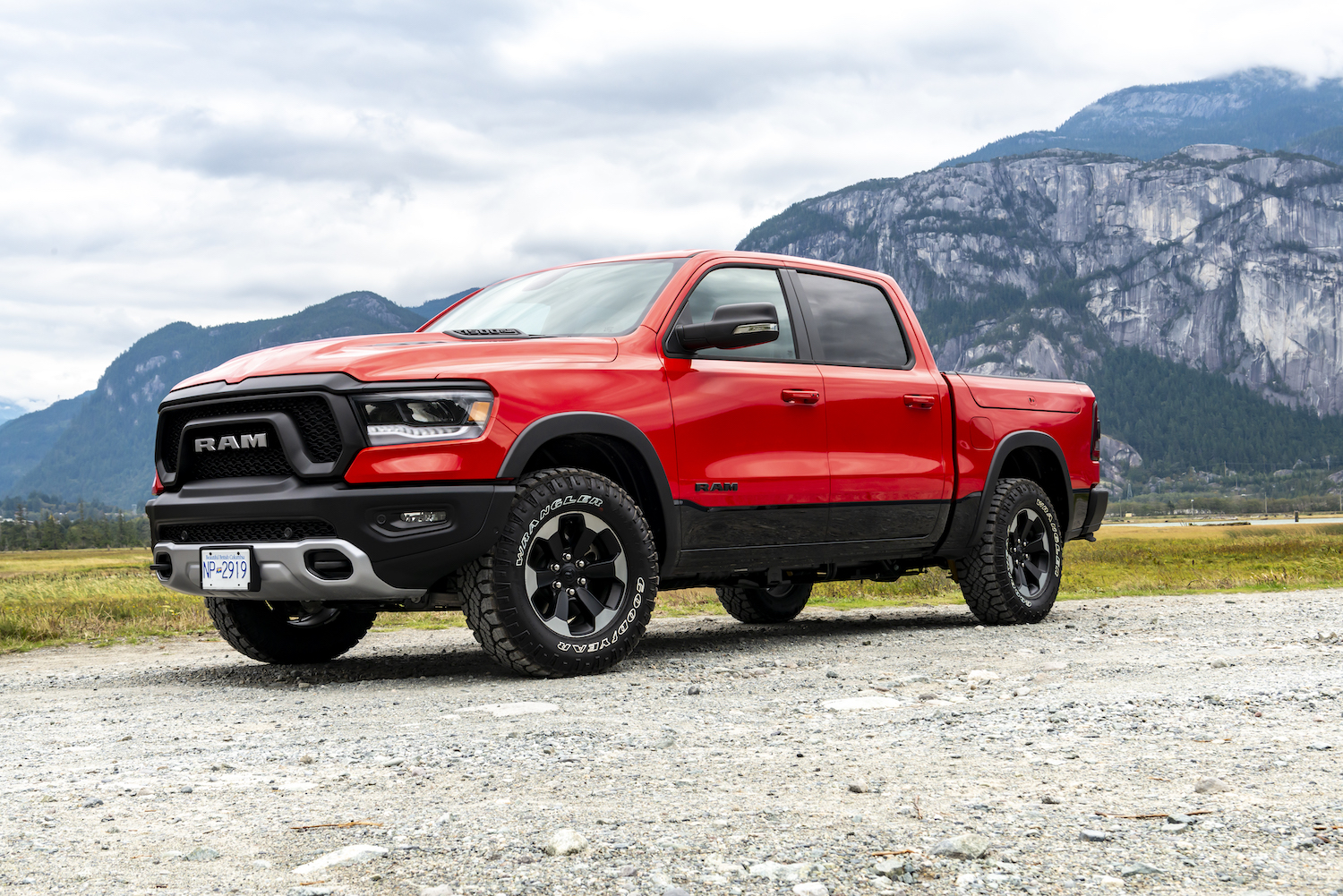 A red 2019 Ram 1500 parked in the mountains