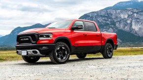 A red 2019 Ram 1500 parked in the mountains