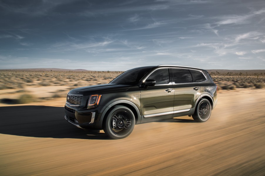 Used cars, like the 2020 Kia Telluride, shown here traveling on a dirt road through a desert, are now selling for more than new ones.