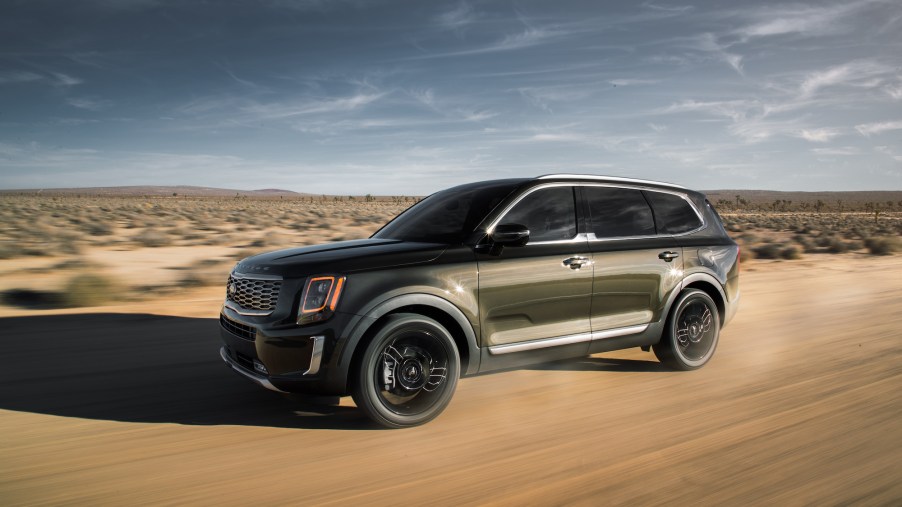 Used cars, like the 2020 Kia Telluride, shown here traveling on a dirt road through a desert, are now selling for more than new ones.