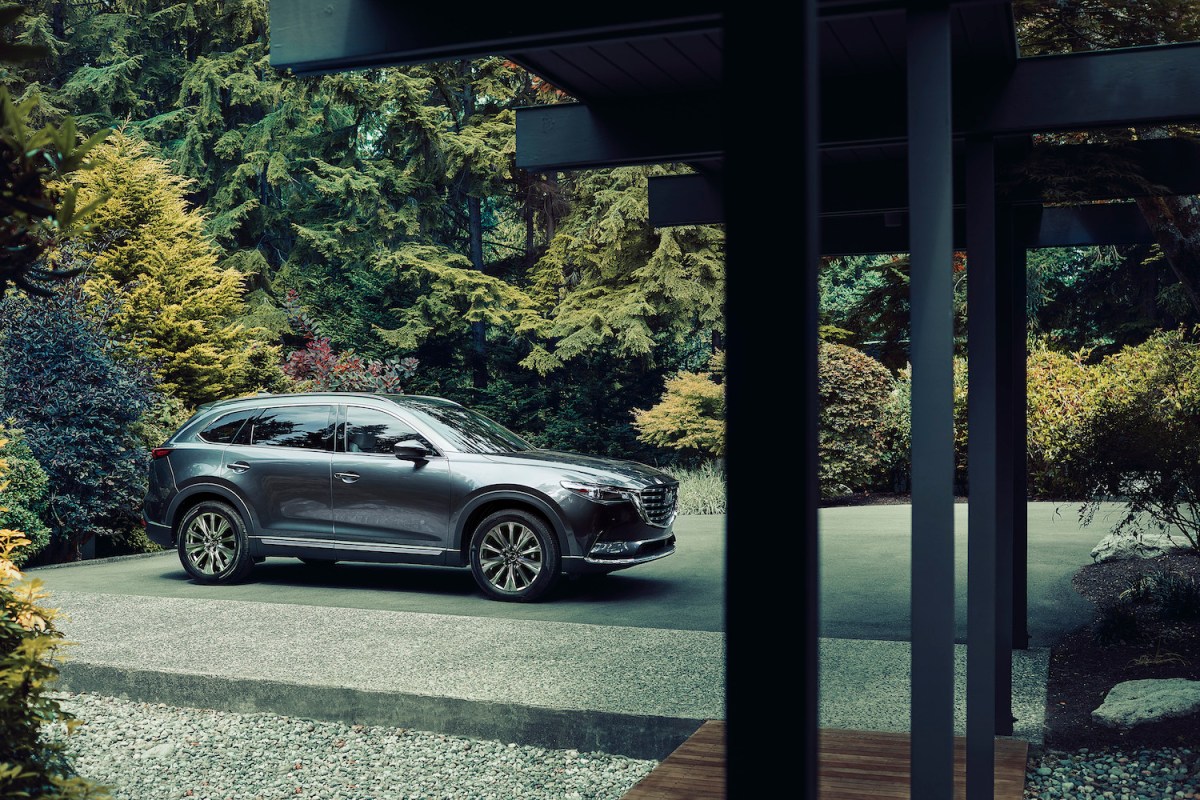 2021 mazda cx-9 parked outside of a house in the woods