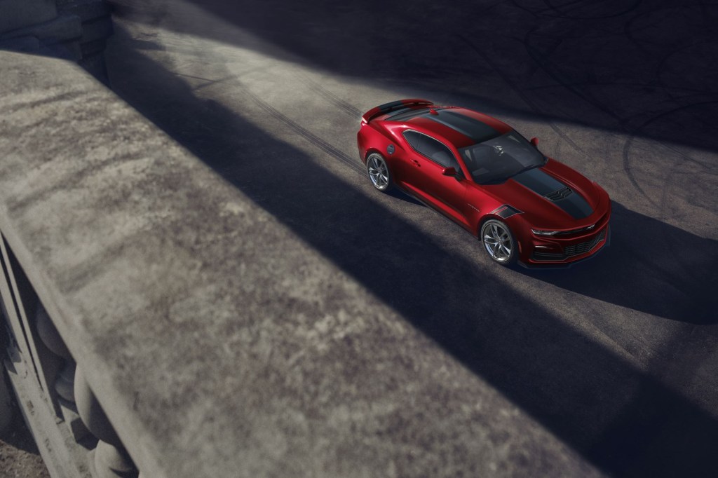The 2021 Chevrolet Camaro in red surrounded by shadows
