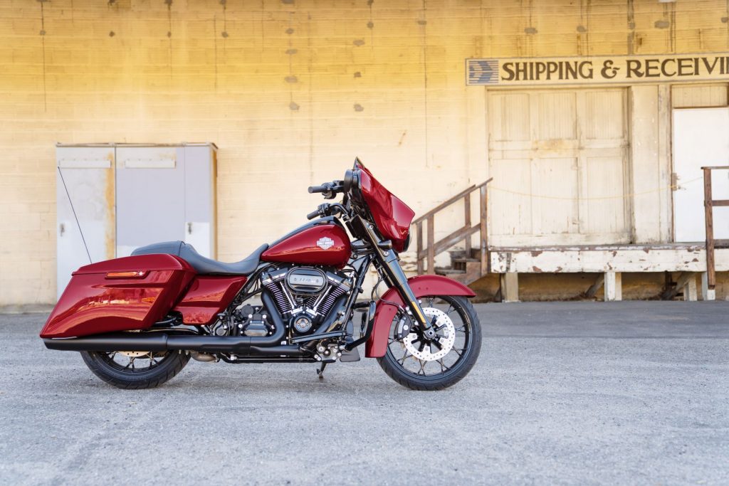 The side view of a red 2021 Harley-Davidson Street Glide Special in front of a yellow building